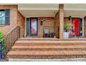 Charming brick front porch with steps, black railing, and classic mailbox, leading to a red front door at 3346 Northcrest Rd # A, Atlanta, GA 30340