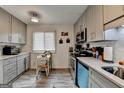Charming kitchen with gray cabinetry, stainless steel appliances, and a cozy dining table by the window at 3346 Northcrest Rd # A, Atlanta, GA 30340