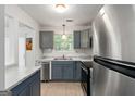 Modern kitchen with stainless steel appliances, gray cabinets, and subway tile backsplash at 4651 Garden Hills Dr, Stone Mountain, GA 30083