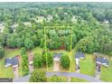 Aerial view of property showcasing the home's position on a 1.02-acre lot surrounded by lush greenery at 240 Mountain Ln, Covington, GA 30016