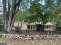 Charming home featuring red shutters, covered porch and a rock retaining wall at 416 Winterwood Dr, Stockbridge, GA 30281