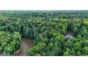 Expansive aerial view of property and mature forest with a nearby river offering both privacy and natural beauty at 2878 Heather Row Sw Rdg, Lilburn, GA 30047