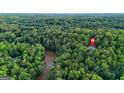 Expansive aerial view of property and mature forest with a nearby river offering both privacy and natural beauty at 2878 Heather Row Sw Rdg, Lilburn, GA 30047
