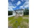 Beautiful two-story home with white siding, black roof, and lush green lawn at 129 Silvercrest Dr # 57, Acworth, GA 30101