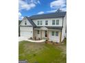 Attractive two-story home featuring a two-car garage, multiple windows, and wooden posts at 129 Silvercrest Dr # 57, Acworth, GA 30101