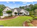 Charming one story home with three car garage, beautifully landscaped yard and stone accents at 134 Mellington Ln, Peachtree City, GA 30269