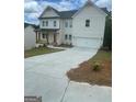 Two-story home with white siding, covered front porch, and a two-car garage with a long driveway at 149 Silvercrest Dr # 58, Acworth, GA 30101
