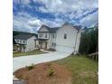 Two-story home with white siding, covered front porch, two-car garage and large driveway at 149 Silvercrest Dr # 58, Acworth, GA 30101