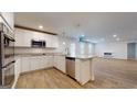 Bright, open-concept kitchen features granite countertops, stainless steel appliances, and island at 95 Jacoby Dr # 103, Fairburn, GA 30213