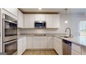 Modern kitchen with stainless appliances, granite counters, and white cabinetry at 95 Jacoby Dr # 103, Fairburn, GA 30213