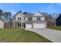 Charming two-story brick home with a well-kept lawn and an attached two-car garage at 112 Felicity Pike, Locust Grove, GA 30248