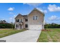 Attractive two-story brick home with a two-car garage, set on a green lot with a concrete driveway at 120 Felicity Pike, Locust Grove, GA 30248