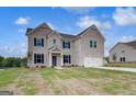 Charming two-story brick home with an attached two-car garage and a well-maintained front yard at 120 Felicity Pike, Locust Grove, GA 30248