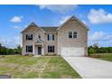 Beautiful two-story brick home featuring a two-car garage, well-kept lawn, and dark blue shutters at 120 Felicity Pike, Locust Grove, GA 30248