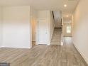 Spacious entryway with beautiful wood-look flooring and staircase leading to the upper level at 220 Fern Dale Dr # 71, Fairburn, GA 30213