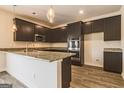 Stylish kitchen with granite countertops, stainless steel appliances, and dark wood cabinets at 220 Fern Dale Dr # 71, Fairburn, GA 30213