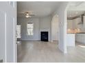 Bright and airy living room with modern fireplace, hardwood floors and contemporary ceiling fan at 221 Ruthe Cv, Locust Grove, GA 30248
