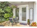 Inviting outdoor patio with lush greenery and a charming seating area, ideal for enjoying a peaceful afternoon at 2694 Greentree Se Dr, Marietta, GA 30067