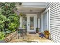 Cozy patio featuring a table, chairs, potted plants and hanging flowers, perfect for outdoor relaxation and entertaining at 2694 Greentree Se Dr, Marietta, GA 30067