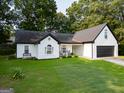 Charming one-story home features a black roof, two-car garage, and a well-manicured lawn at 1612 Cagle Ct, Lawrenceville, GA 30045