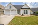Attractive home featuring a three-car garage and a meticulously kept front lawn at 240 Turnbridge Cir, Peachtree City, GA 30269