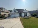 Bright single-story home featuring a two-car garage and a well-maintained lawn in a suburban setting at 240 Turnbridge Cir, Peachtree City, GA 30269