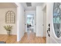 Bright hallway features hardwood floors, white wall paneling and access to multiple rooms at 100 Willow Wood Road, Social Circle, GA 30025