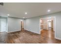 Spacious living room featuring beautiful hardwood floors, neutral wall color, and multiple doorways at 489 Radar Dr, Hapeville, GA 30354