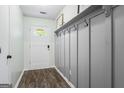Inviting entryway featuring coat hooks, wood-look floors, and natural light at 200 Pine Tree Ln, Mcdonough, GA 30252