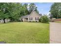 Traditional-style home featuring a spacious front yard and inviting curb appeal at 200 Pine Tree Ln, Mcdonough, GA 30252