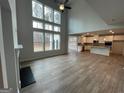Bright open-concept living space with fireplace, high ceilings, large windows and views into the kitchen at 821 Dobby Way # 97, Mcdonough, GA 30252