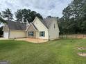 Well maintained home with a large, green lawn and a small rock garden area with small bordering lights at 521 Deadwood Trl, Locust Grove, GA 30248