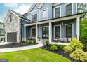 Charming exterior with a welcoming porch and beautifully landscaped front yard at 5490 Bent Grass Way, Douglasville, GA 30135