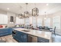 Modern kitchen with stainless steel appliances, large island, and stylish lighting at 5490 Bent Grass Way, Douglasville, GA 30135