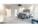 Spacious main bedroom with neutral tones, a ceiling fan and plush carpet at 5490 Bent Grass Way, Douglasville, GA 30135