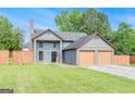 Charming two-story home features a spacious two-car garage and beautifully maintained lawn at 548 Thomas Downs Way, Jonesboro, GA 30238
