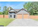 Charming two-story home features a spacious two-car garage and beautifully maintained lawn at 548 Thomas Downs Way, Jonesboro, GA 30238