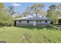 Charming single-story home with a well-maintained lawn and inviting curb appeal during daytime at 758 King Rd, Jonesboro, GA 30236
