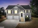 Charming two-story home with a two-car garage, stairs to entryway, and manicured front yard at 8870 Dornoch Cir, Winston, GA 30187