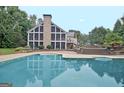 Expansive pool and screened-in porch on a multi-level deck create a relaxing outdoor retreat at 104 Hidden Springs Ln, Peachtree City, GA 30269