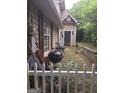 Backyard, showing side of house, shed, fence, and features of the yard at 212 Little Se St, Atlanta, GA 30315