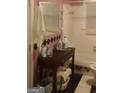 Bathroom featuring white tile, with some pink and black accents, with a shower, sink, and toilet at 212 Little Se St, Atlanta, GA 30315