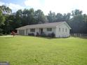 Lovely one-story house with a brick exterior, mature landscaping, and a well-maintained front lawn at 3025 Ebenezer Rd., Se Rd, Conyers, GA 30094