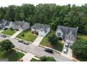 A high angle drone view showcases the homes in a Gathering-friendly neighborhood with tree-lined streets and well-kept yards at 3205 Anneewakee Falls Pkwy, Douglasville, GA 30135