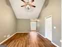 Bright living room with vaulted ceilings and wood floors leading to the front entrance at 106 Oakwood Cir, Stockbridge, GA 30281