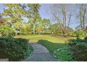 Lush front yard with mature trees and sidewalk at 100 Clydesdale Ct, Tyrone, GA 30290