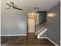 Open living area features hardwood floors, a ceiling fan, and a staircase leading to the upper level at 106 Ne Ellis Dr # 106, Conyers, GA 30012