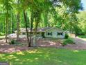 Landscaped front yard with a well-maintained lawn and mature trees surrounding the house at 1379 Branchwood Dr, Snellville, GA 30078