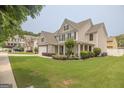 Lovely two-story home with a green lawn and inviting curb appeal in a neighborhood setting at 3338 Gardenside Walk, Loganville, GA 30052