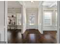 Inviting foyer with dark hardwood floors, detailed trim, and a clear view of the front door at 6857 Louis Dr, Locust Grove, GA 30248